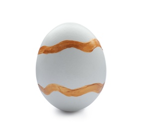 Traditional Easter egg decorated with golden paint on white background