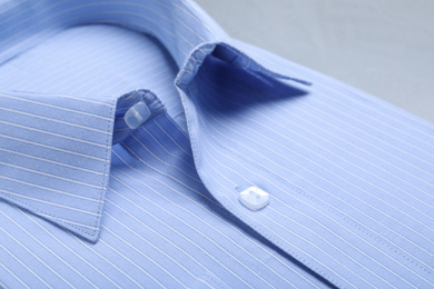 Closeup view of stylish light blue shirt. Dry-cleaning service