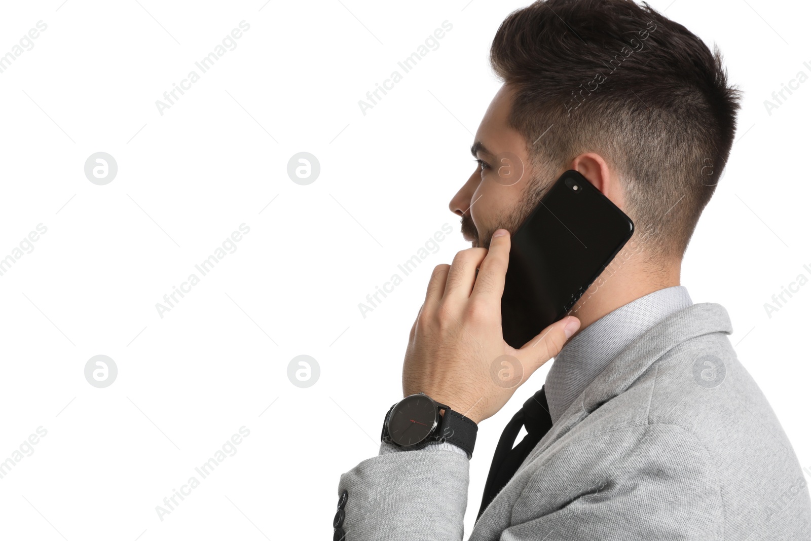 Photo of Young businessman talking on smartphone against white background
