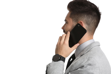 Photo of Young businessman talking on smartphone against white background