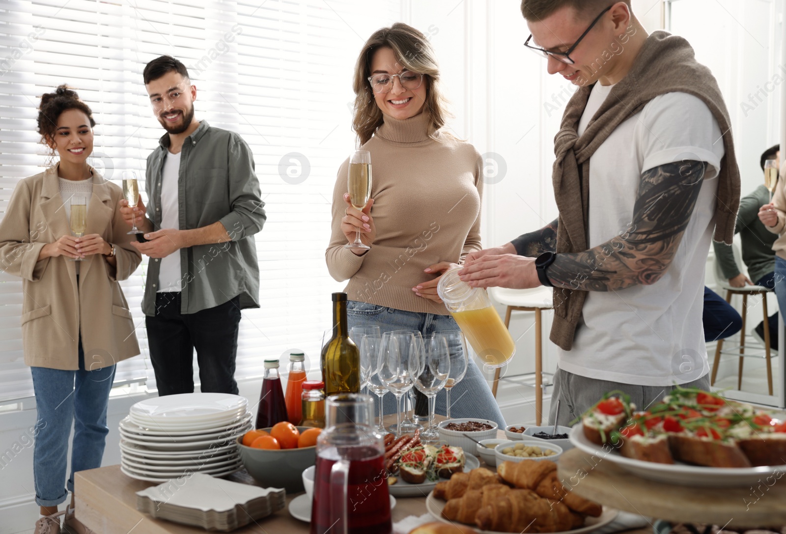 Photo of Group of people enjoying brunch buffet together indoors