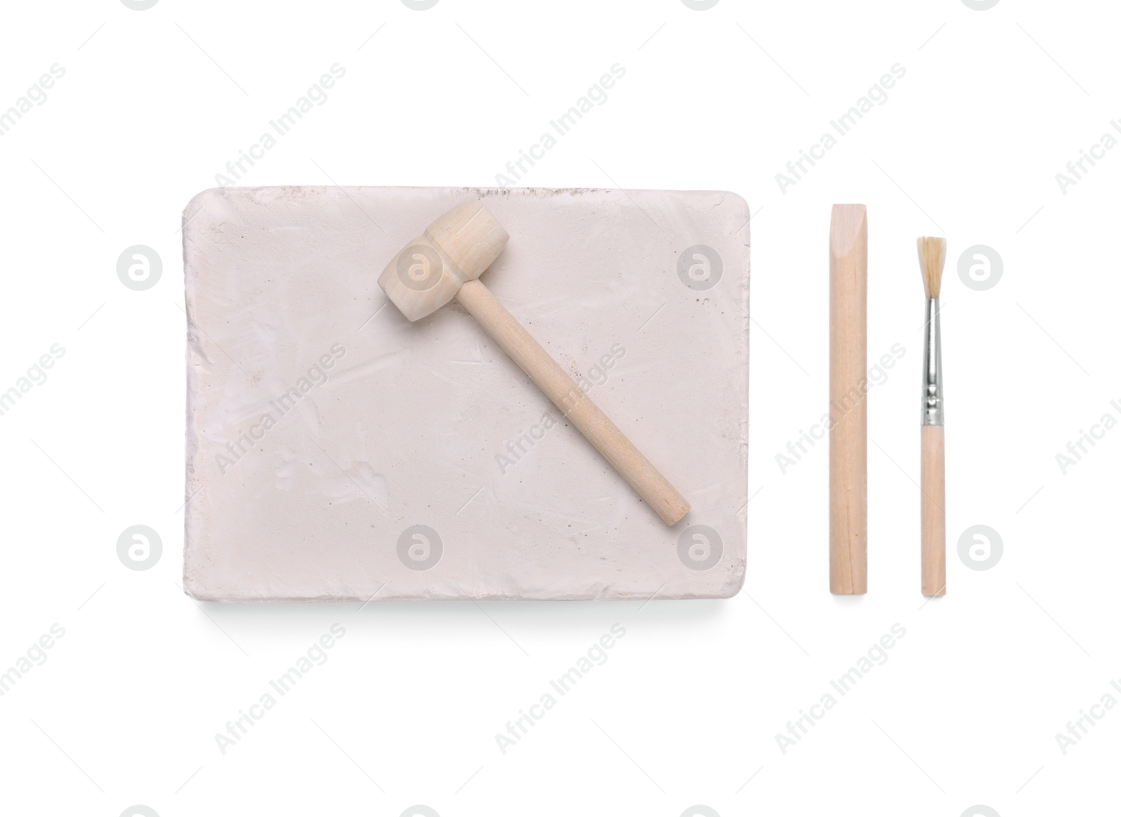 Photo of Educational toy for motor skills development. Excavation kit (plaster, digging tools and brush) isolated on white, top view