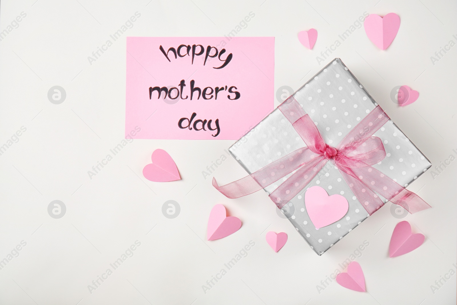 Photo of Flat lay composition with paper hearts and elegant gift box for Mother's Day on light background