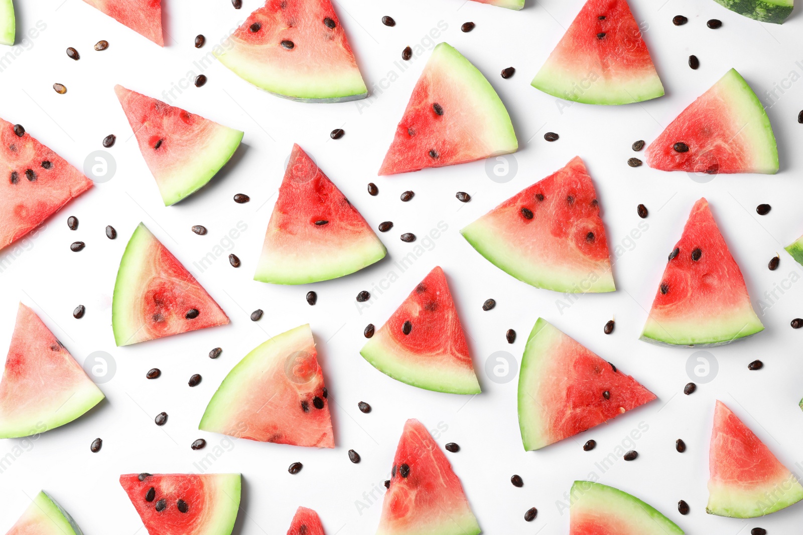 Photo of Flat lay composition with slices and seeds of watermelon on white background