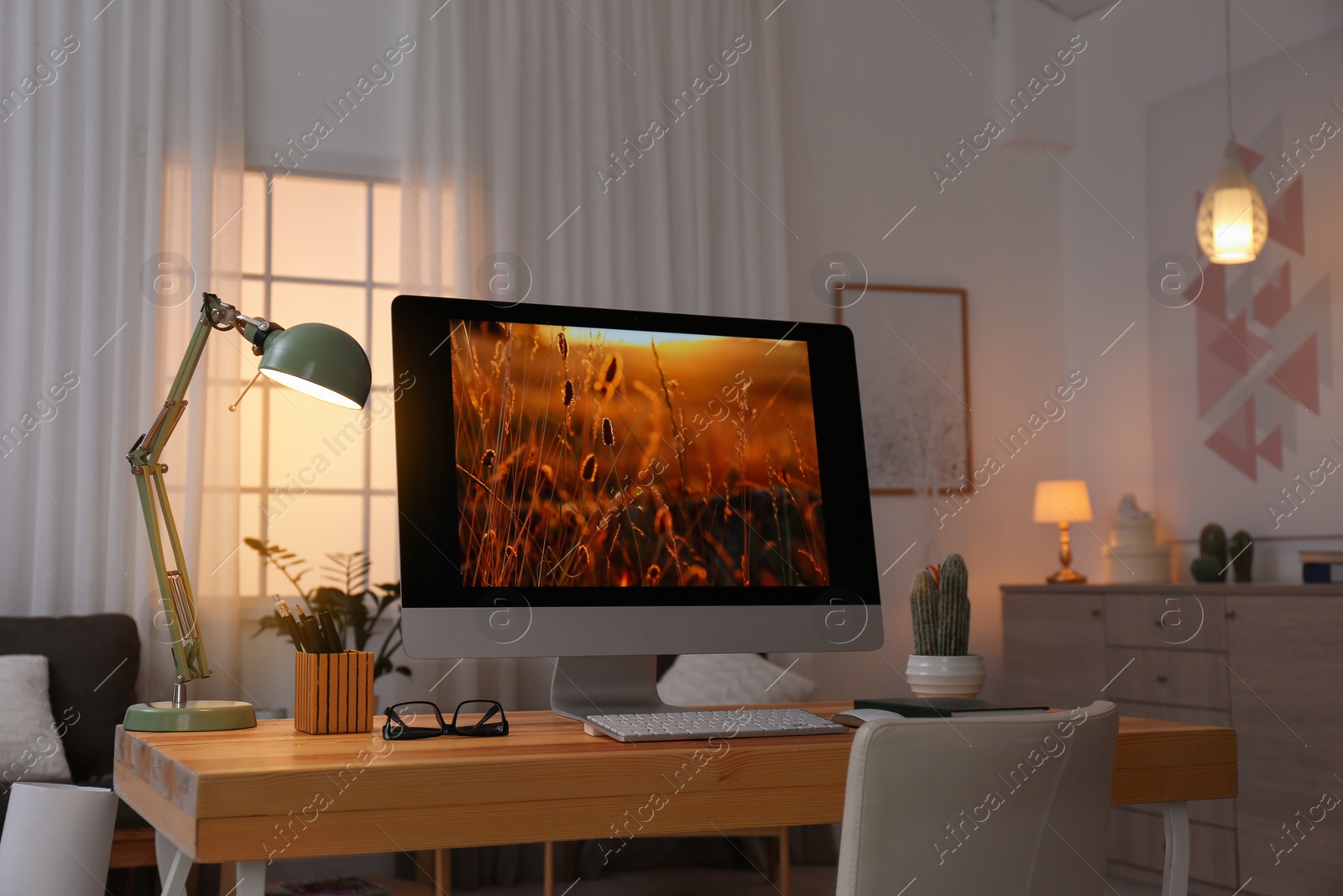 Photo of Comfortable workplace with modern computer on desk. Home office