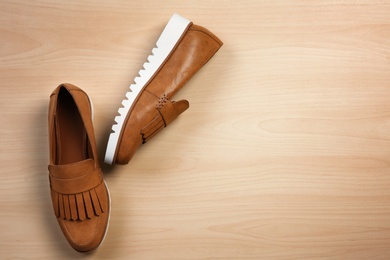 Photo of Pair of female shoes on wooden background