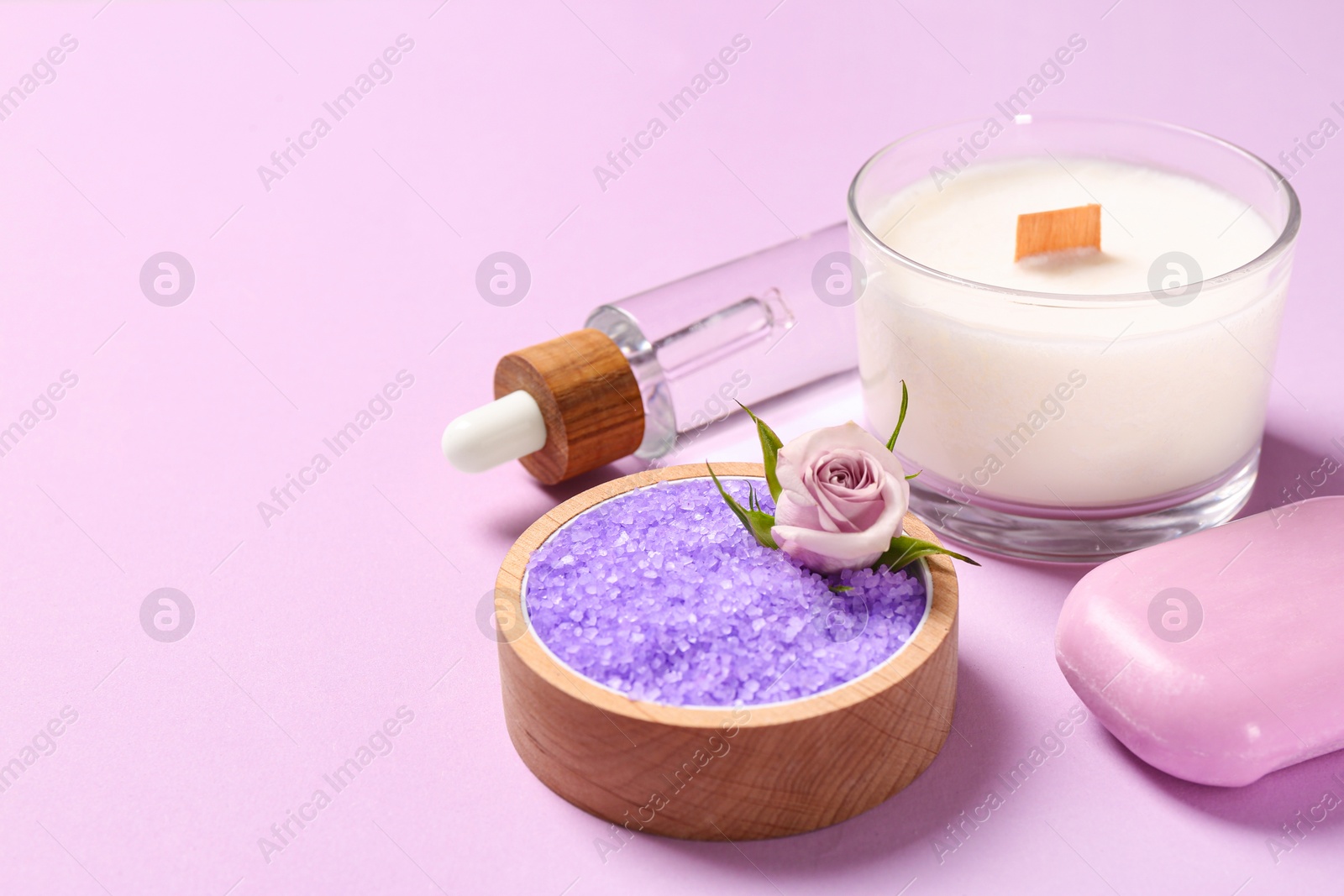 Photo of Sea salt, candle and soap bar on pink background. Space for text