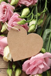 Photo of Happy Mother's Day. Beautiful flowers and blank heart shaped card on wooden table