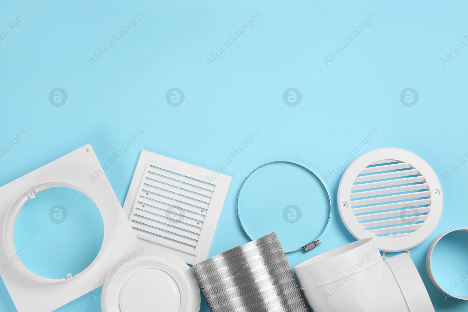 Photo of Parts of home ventilation system on light blue background, flat lay. Space for text