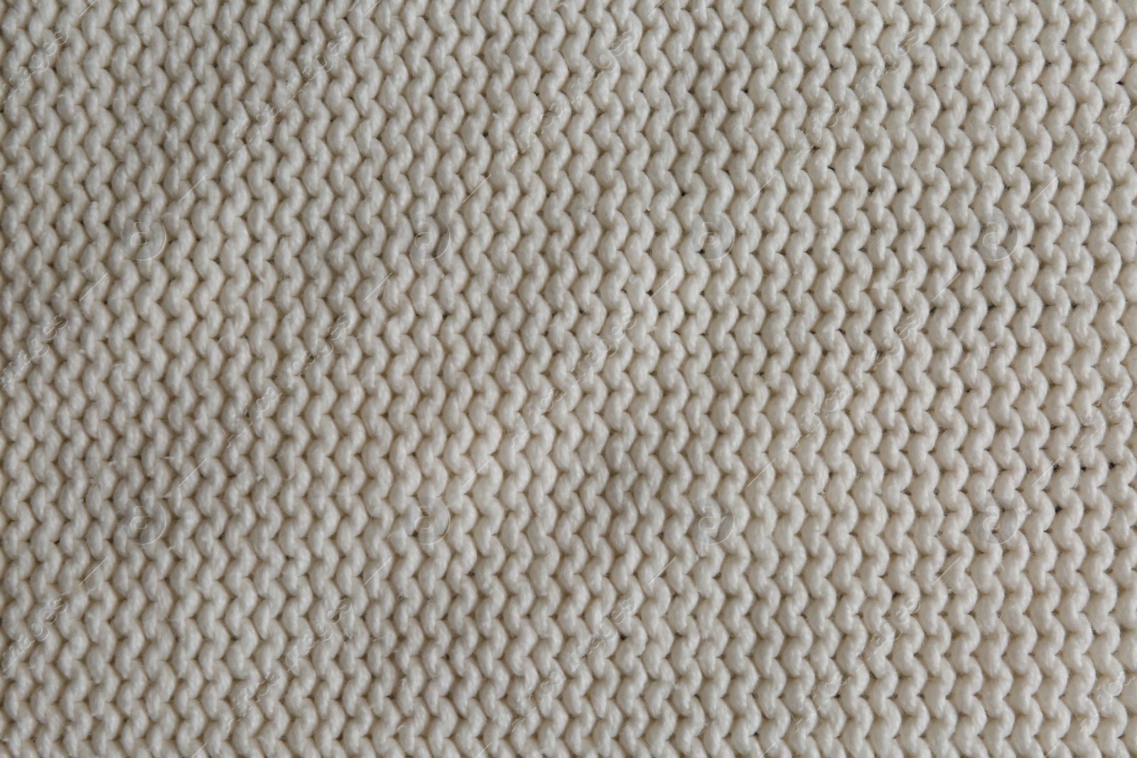 Photo of Beautiful white knitted fabric as background, top view