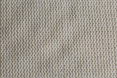 Photo of Beautiful white knitted fabric as background, top view