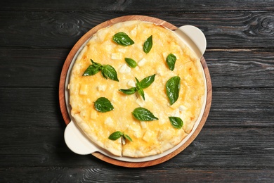 Photo of Fresh tasty homemade pizza on wooden background, top view