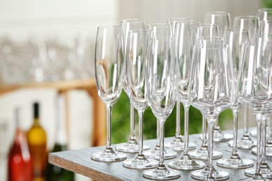 Empty glasses on wooden table against blurred background