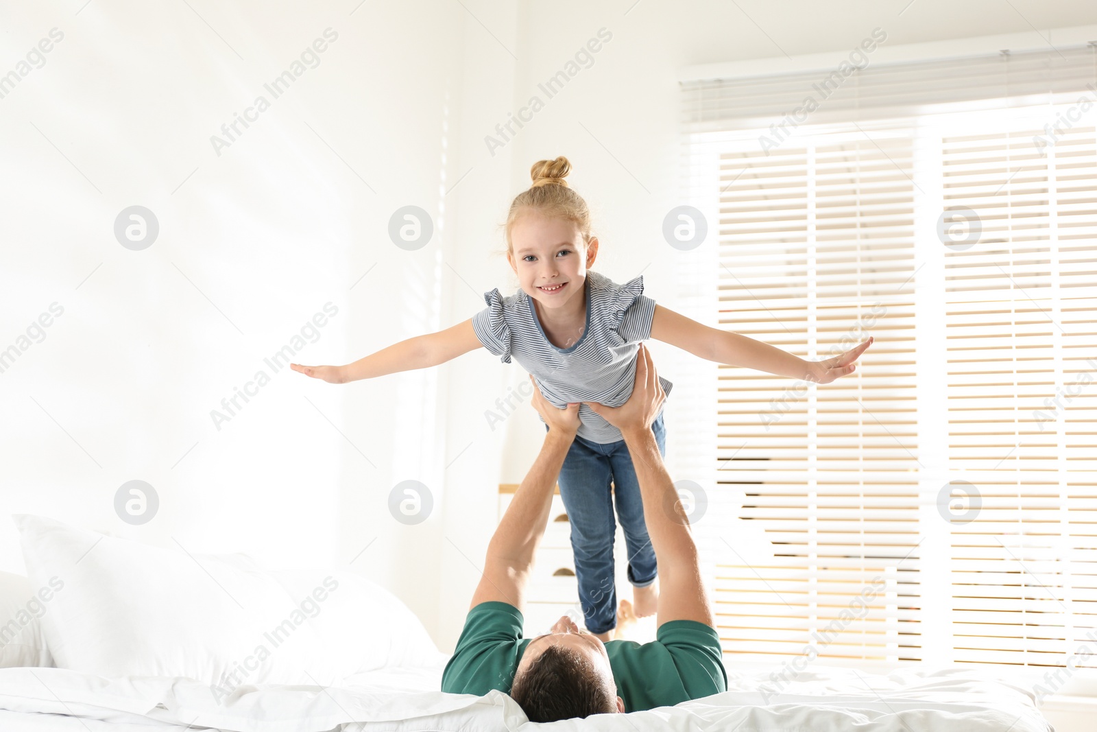 Photo of Dad and daughter having fun together at home. Happy Father's Day