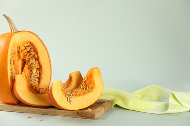 Photo of Cut fresh ripe pumpkin on white background, space for text