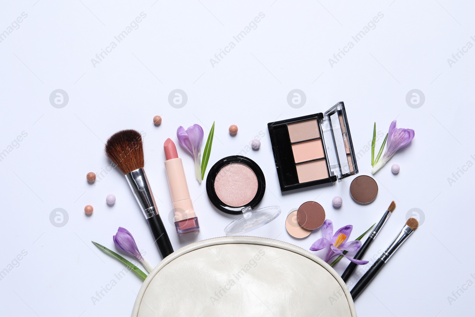 Photo of Flat lay composition with different makeup products and beautiful flowers on white background, space for text