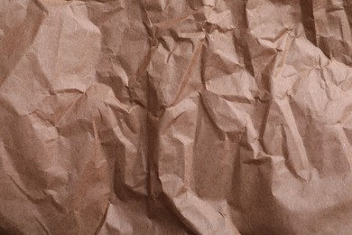 Photo of Texture of wrinkled kraft paper bag as background, closeup