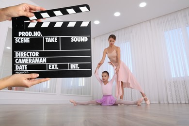 Image of Shooting movie. Second assistant camera holding clapperboard in front of ballet teacher and girl (actors) at dance studio (film set)