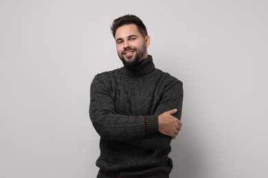 Happy man in stylish sweater on white background