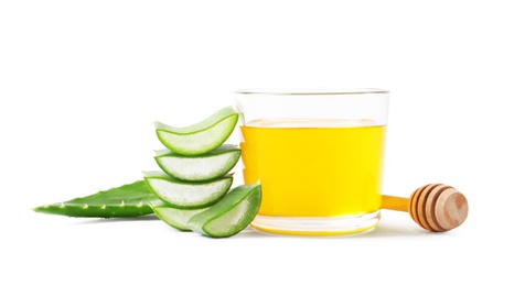 Photo of Glass of honey and aloe vera on white background