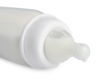 One feeding bottle with infant formula on white background, closeup
