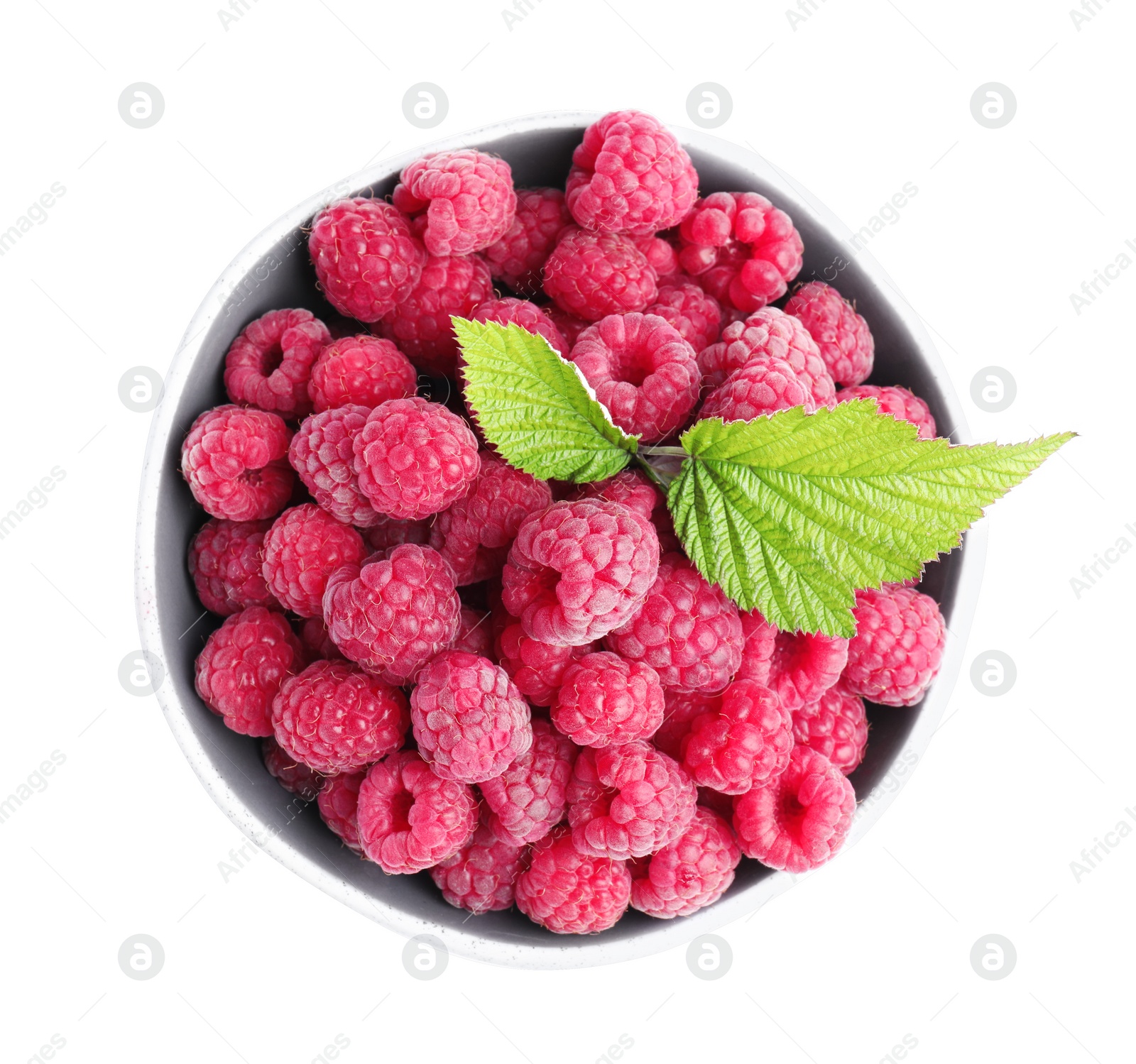 Photo of Bowl of fresh ripe raspberries with green leaves isolated on white, top view