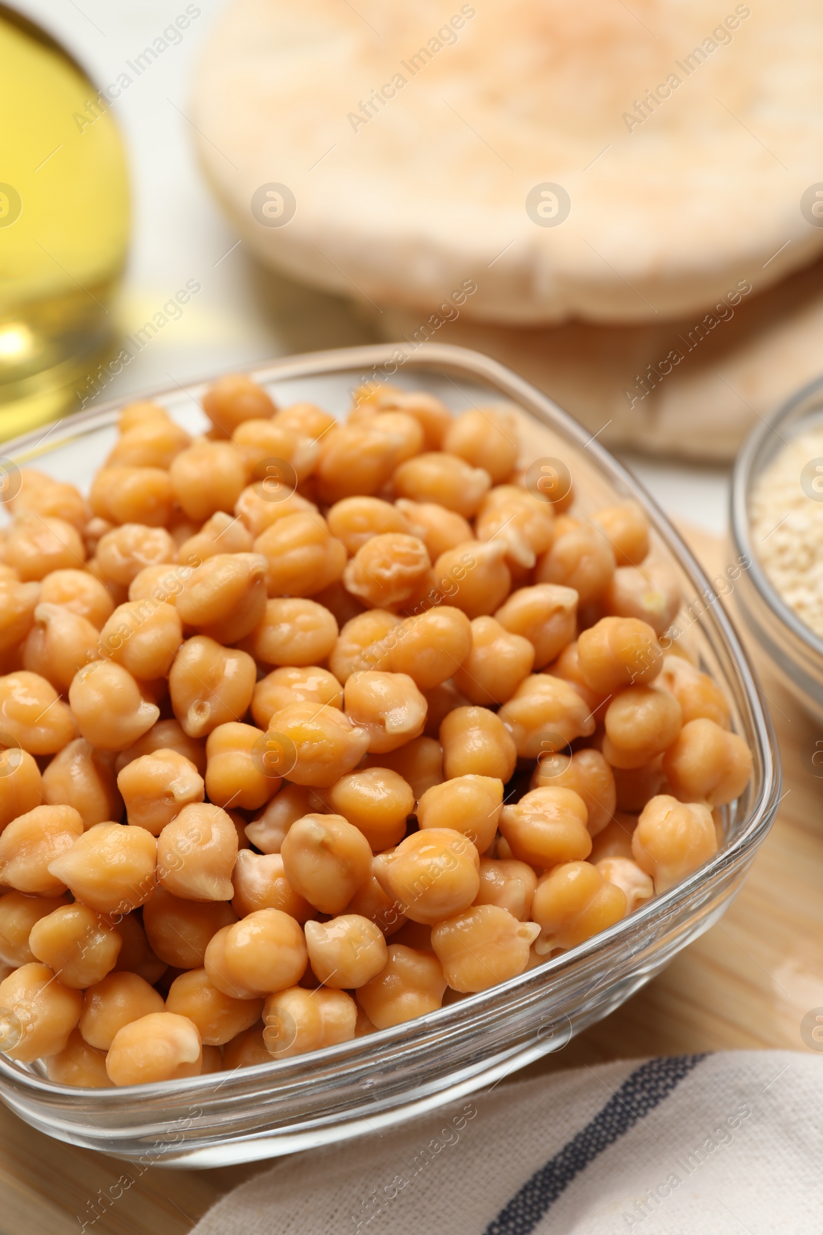 Photo of Delicious chickpeas on white table. Hummus ingredients