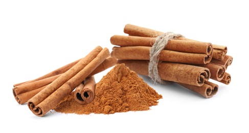 Image of Aromatic cinnamon sticks and powder on white background