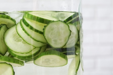 Photo of Large jar of fresh cucumber water, closeup