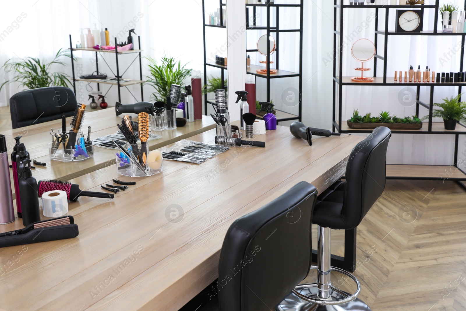 Photo of Stylish beauty salon interior with hairdresser's workplace