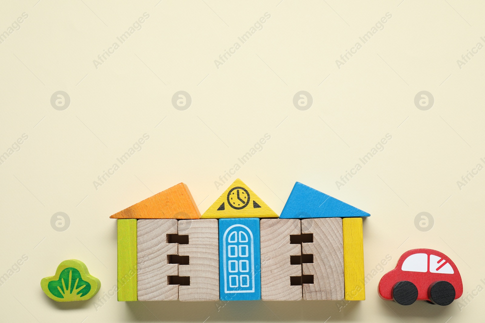 Photo of Set of wooden toys on beige background, flat lay with space for text. Children's development