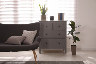 Photo of Stylish living room interior with comfortable sofa and plants near window