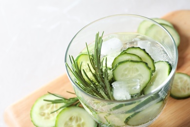 Photo of Glass of fresh cucumber water on table, closeup