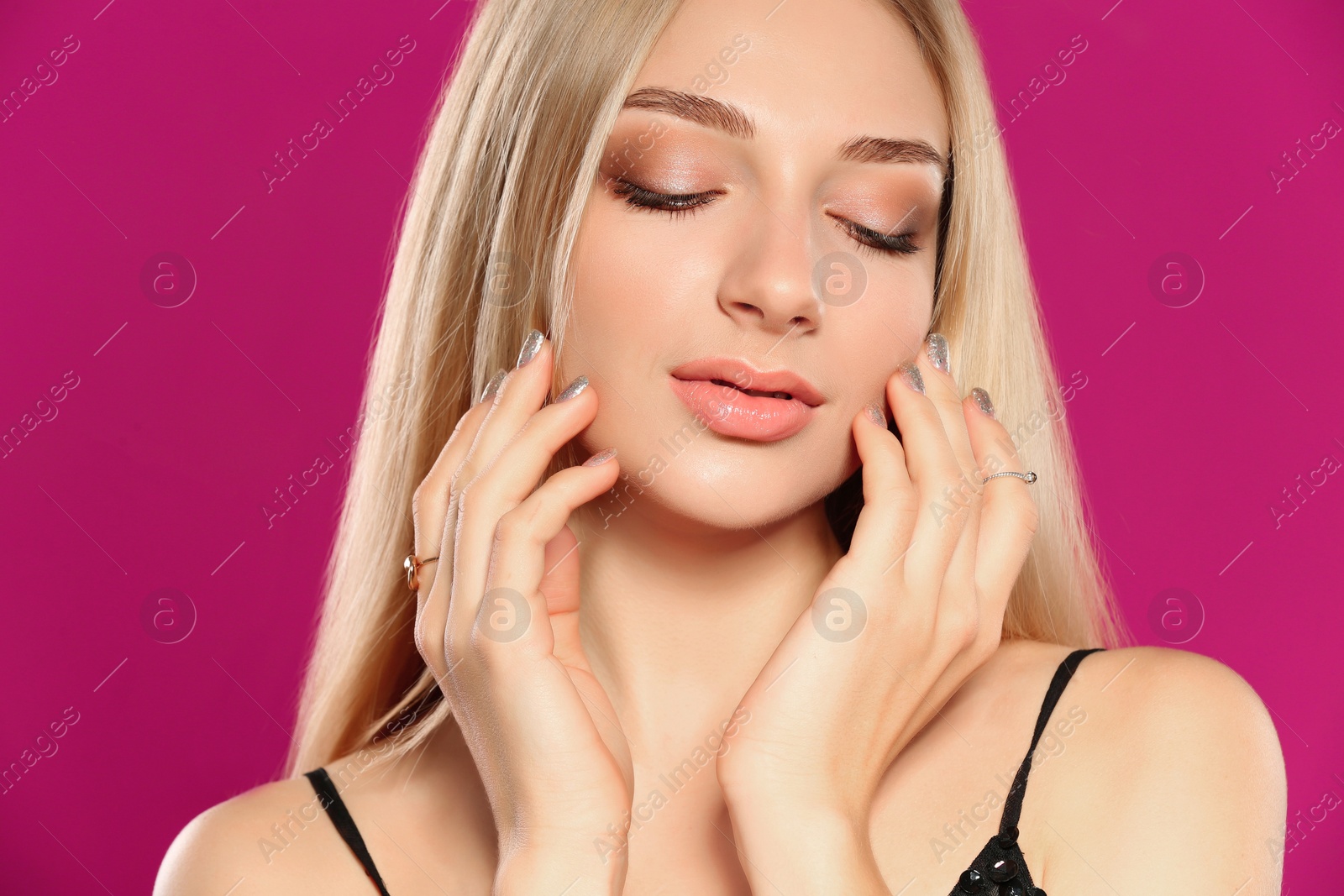 Photo of Beautiful young woman with shiny manicure on color background, closeup. Nail polish trends