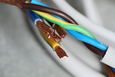 Photo of Colorful electrical wires on blurred background, closeup