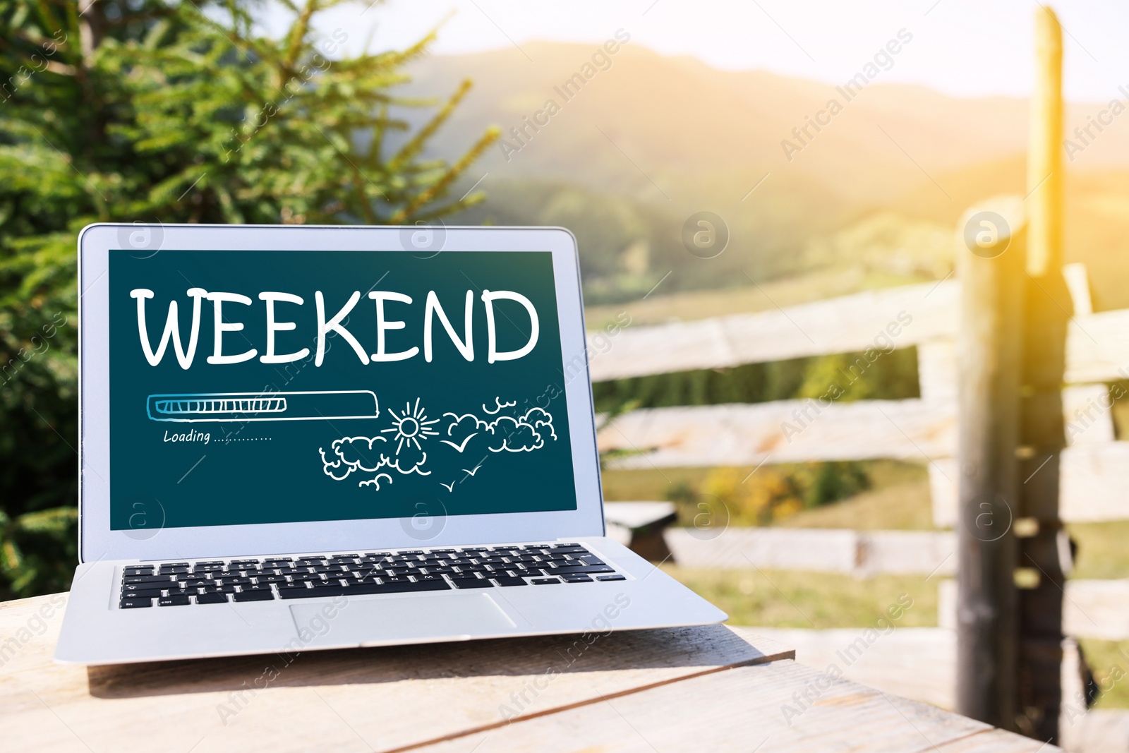 Image of Weekend coming soon. Laptop on wooden table in mountains