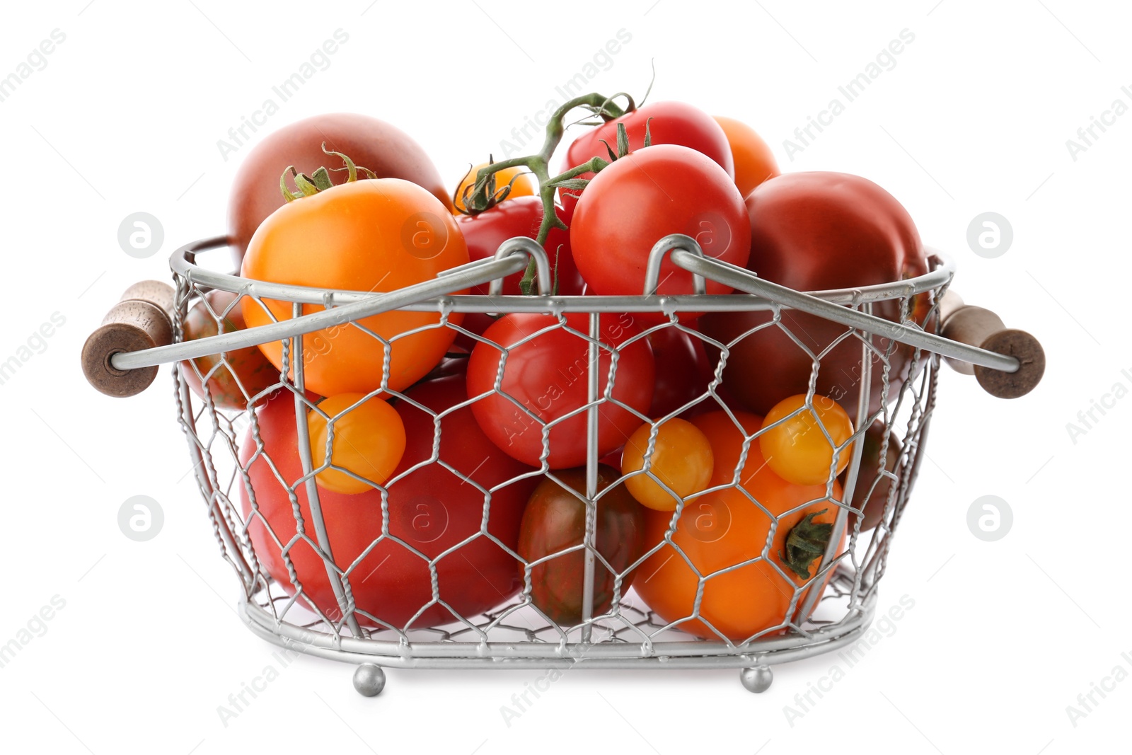 Photo of Fresh ripe yellow and red tomatoes in metal basket on white background