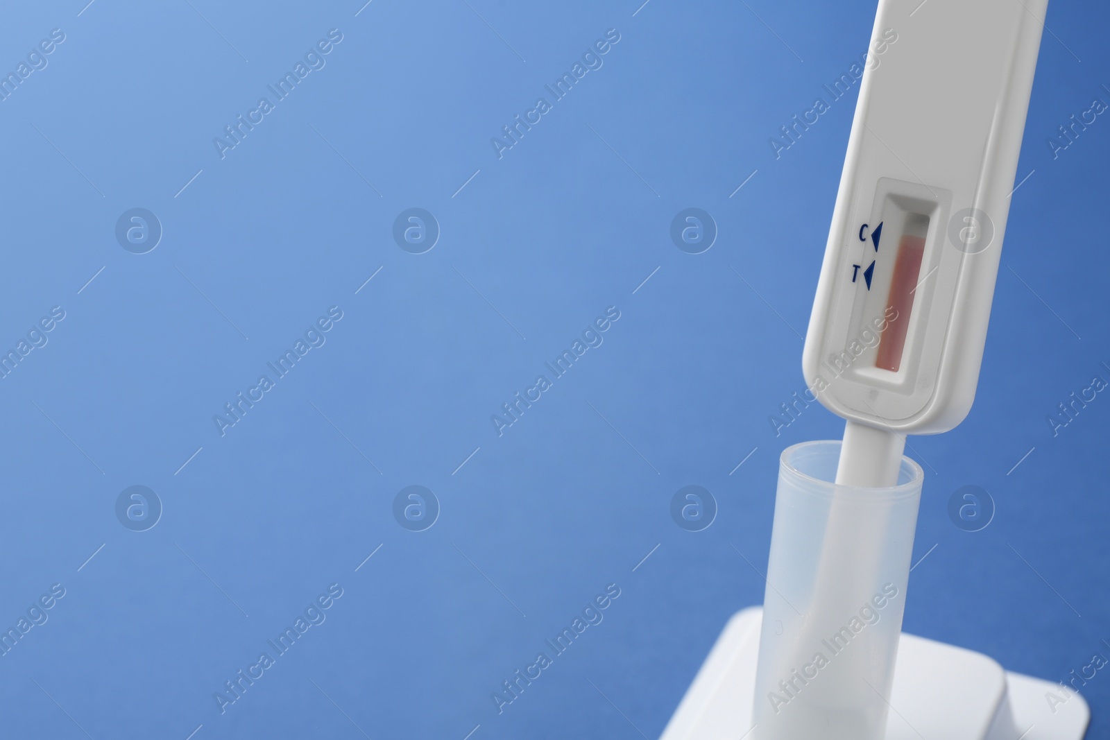 Photo of Disposable express test on blue background, closeup. Space for text