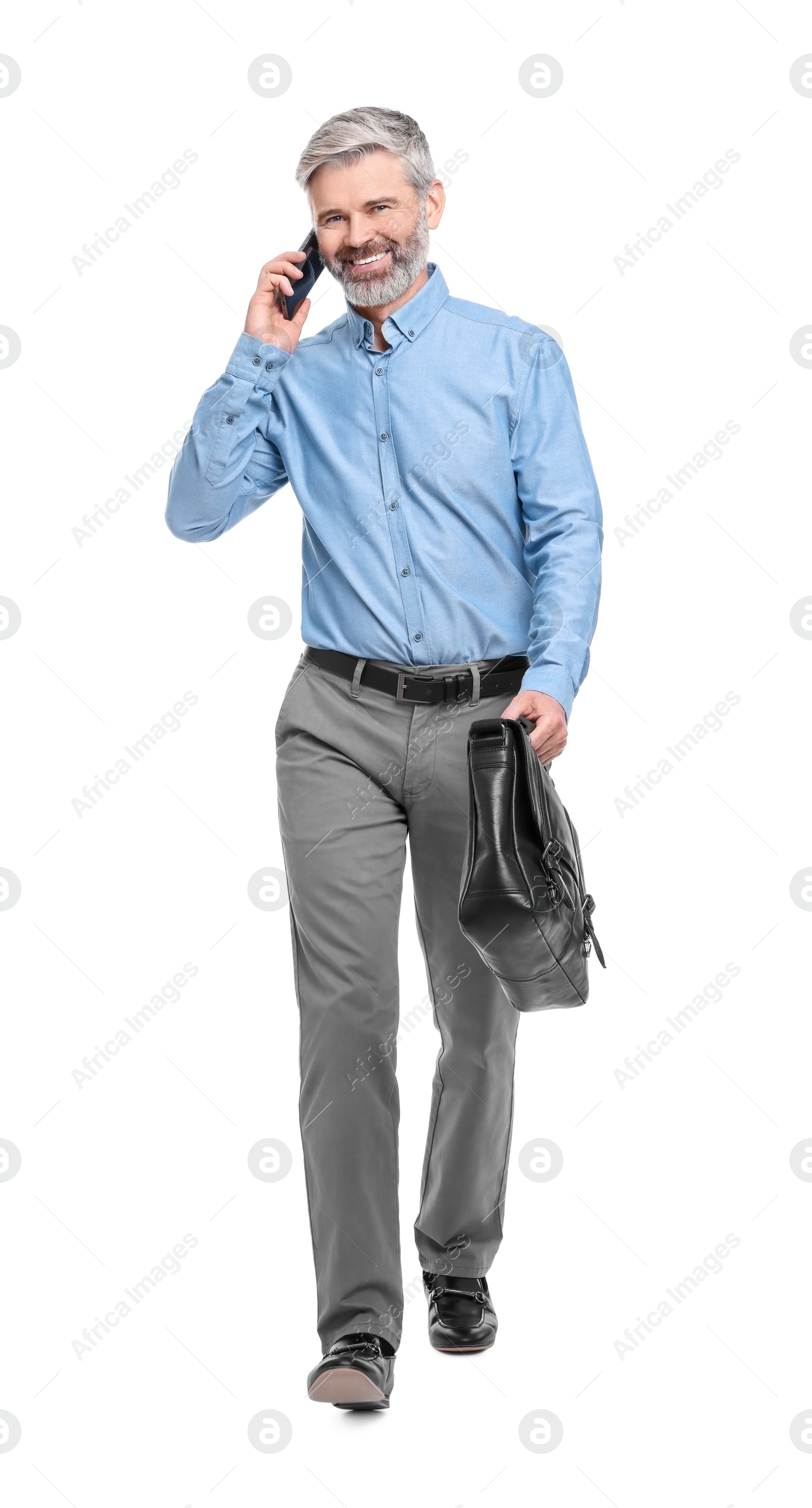 Photo of Mature businessman talking on smartphone against white background