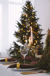 Beautiful table setting with Christmas decor in room