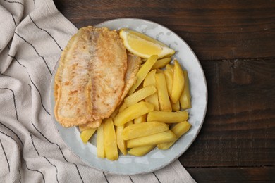 Photo of Delicious fish and chips on wooden table, top view
