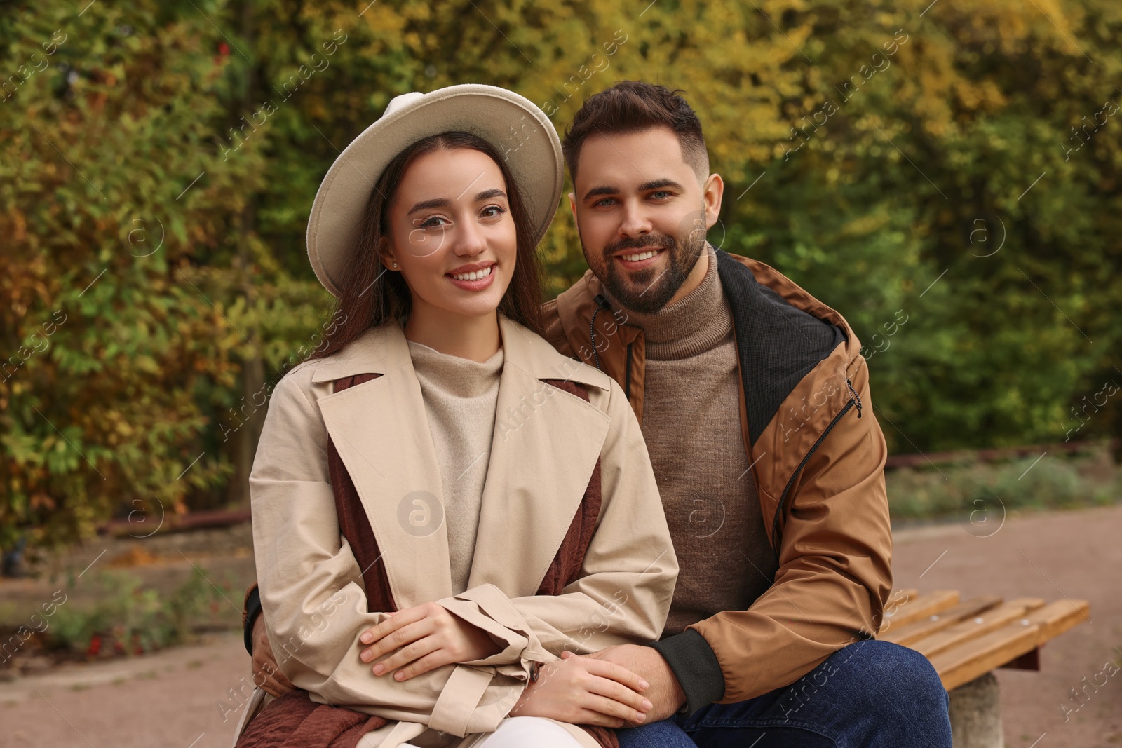 Photo of Happy young couple spending time together in autumn park