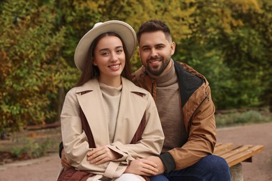 Photo of Happy young couple spending time together in autumn park