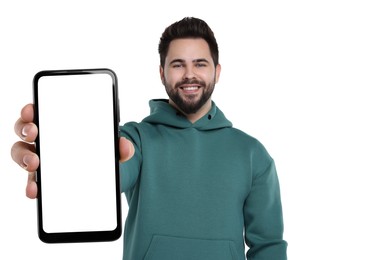 Image of Happy man holding smartphone with empty screen on white background