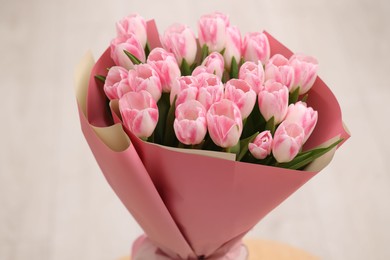 Beautiful bouquet of fresh pink tulips on blurred background, closeup