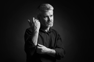 Portrait of handsome man on dark background. Black and white effect