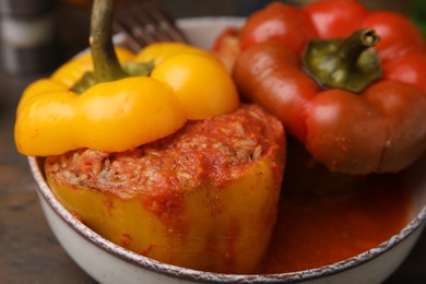 Photo of Delicious stuffed bell peppers served on wooden table, closeup