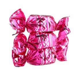 Photo of Candies in bright pink wrappers isolated on white