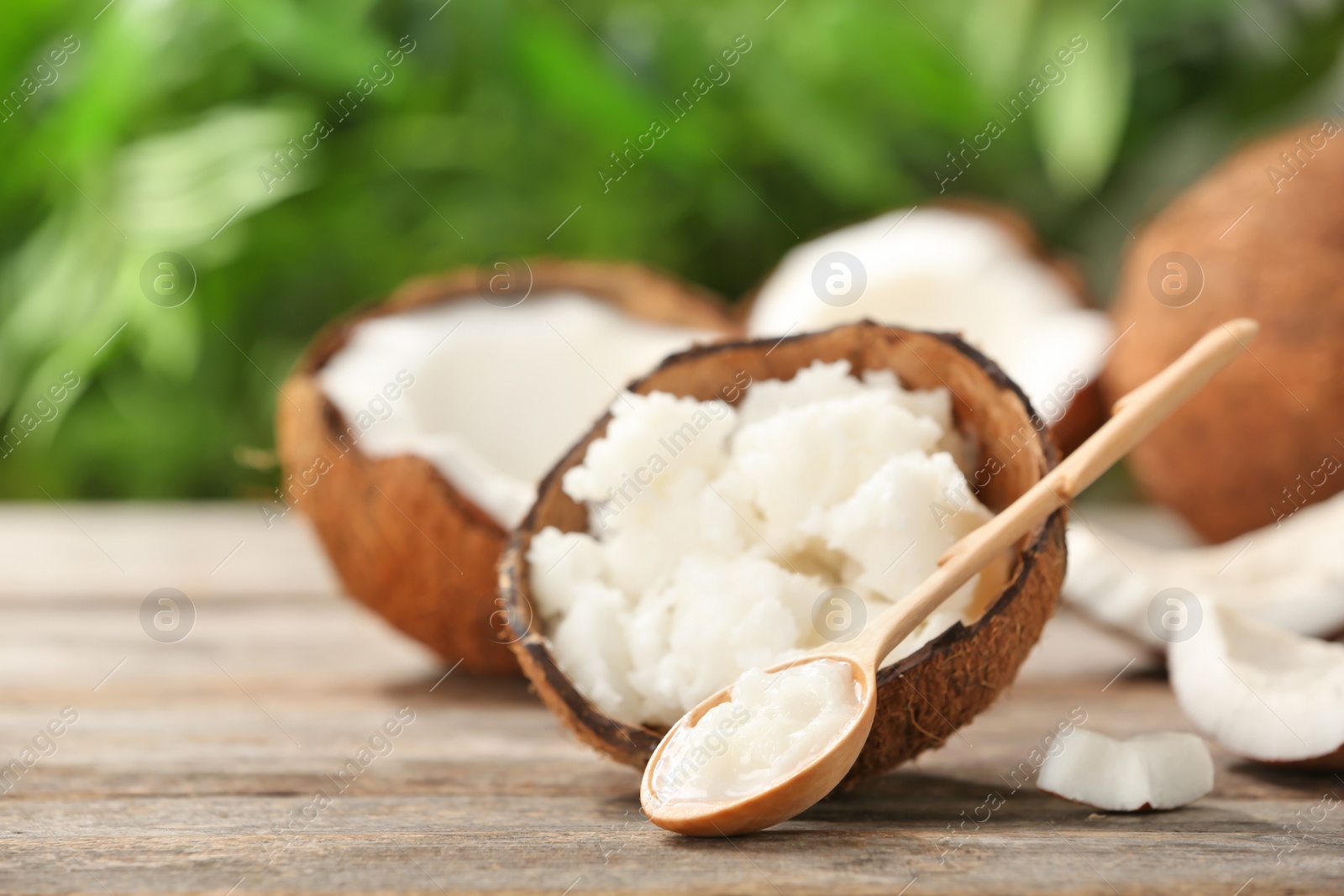 Photo of Composition with coconut oil on table against blurred background. Healthy cooking