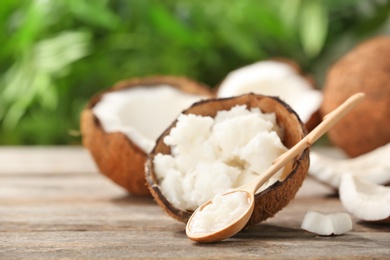 Composition with coconut oil on table against blurred background. Healthy cooking